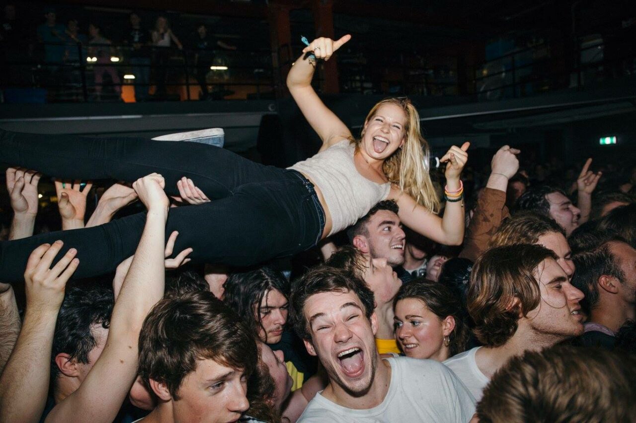 Energetic Crowd at Selina's Sydney: Enjoying Live Music and Crowd Surfing